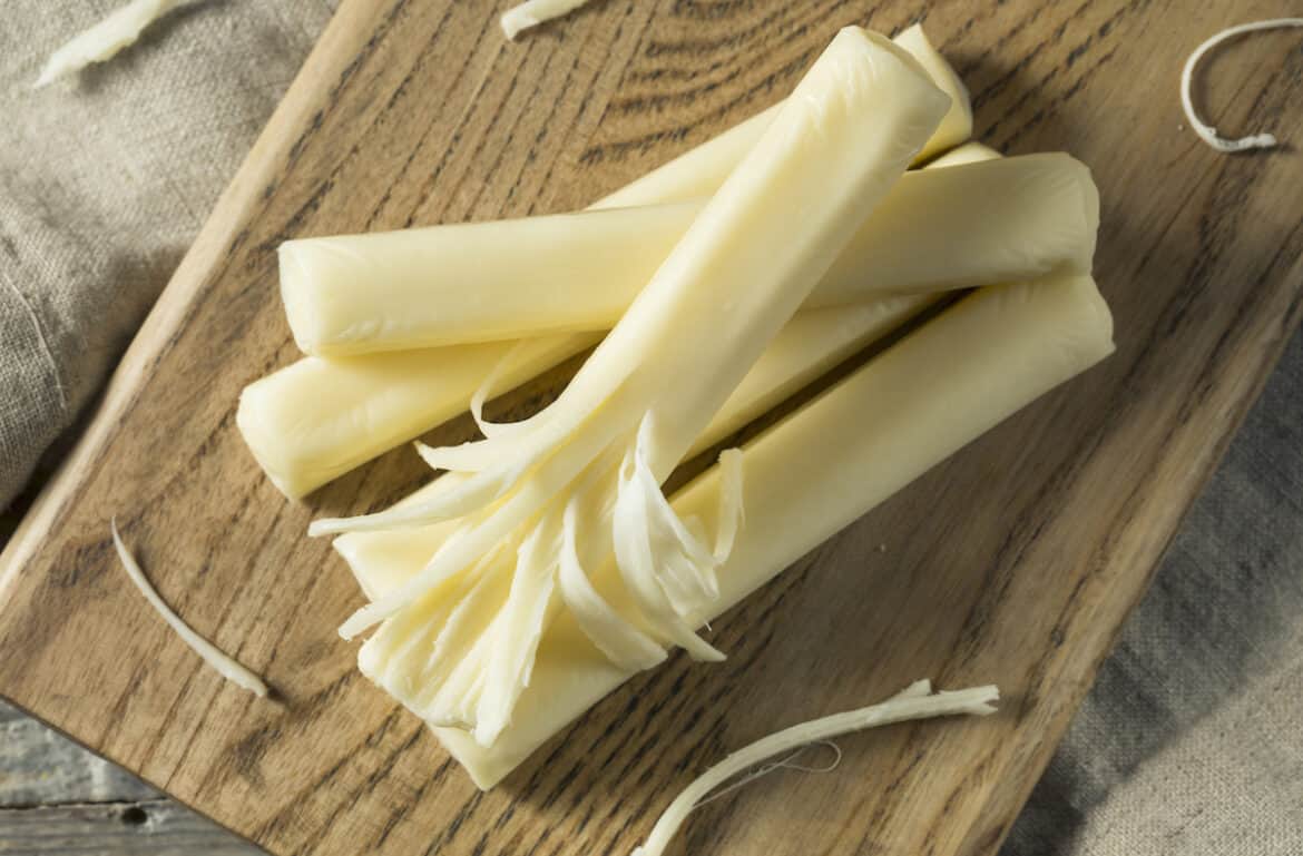 string cheese on a wood cutting board