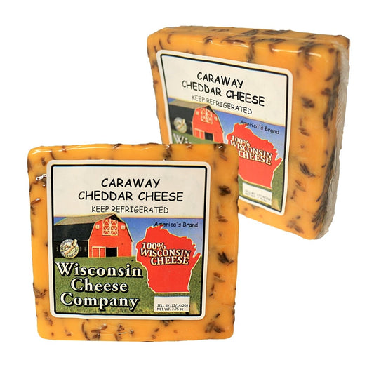Two blocks of Caraway Cheddar Cheese